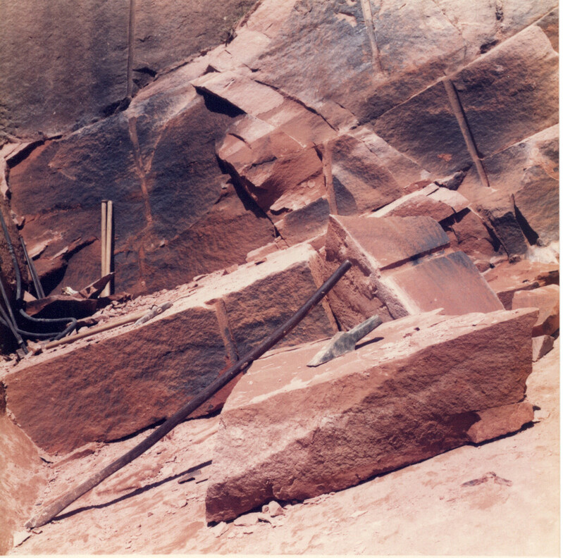 The worked face in a quarry of the Locharbriggs Cluster, photographed in 1984. Powder holes and the tools used to extract sandstone blocks are visible.